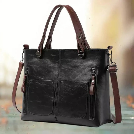 Structured black leather tote bag with polished silhouette, spacious organization for professionals