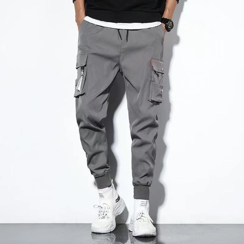 Men's oversized cargo pants relaxed fit solid color with multiple large flap pockets for outdoor wear