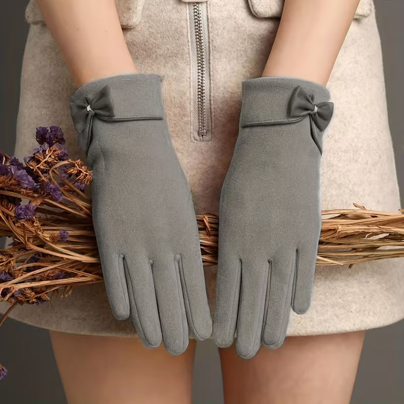 Women's brown suede winter gloves with wrist bow detail and touchscreen-compatible thermal fleece lining
