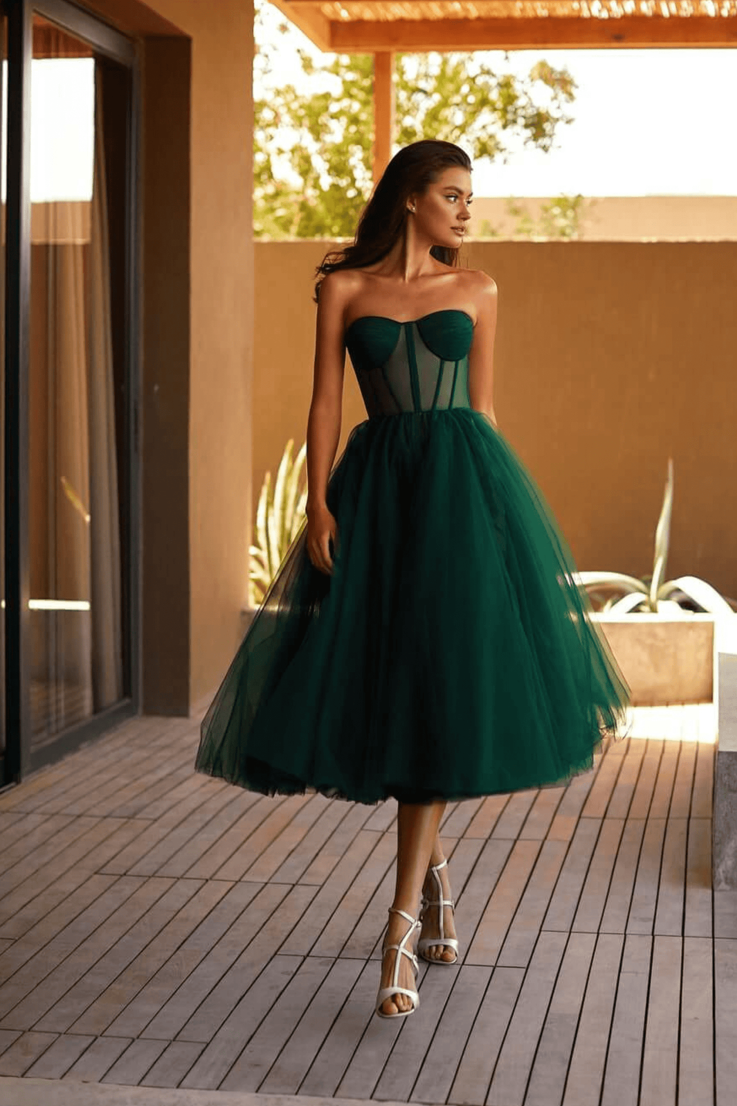Black strapless tulle evening gown structured bodice voluminous multi-layer skirt bold elegant
