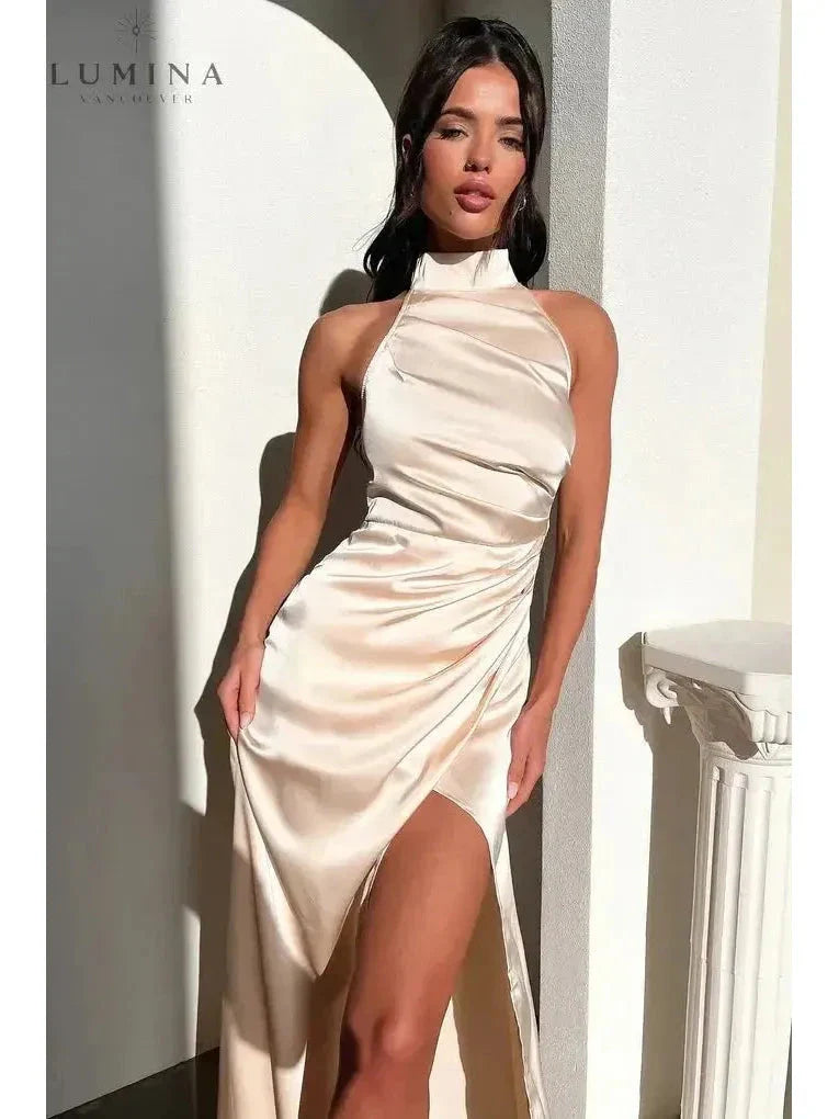Elegant halterneck sleeveless maxi dress with daring side slit, glamorous evening statement piece