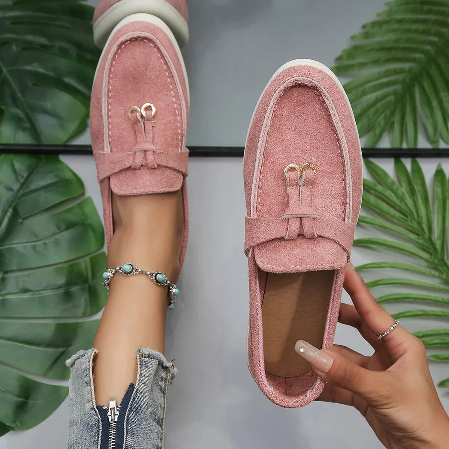Women's black PU leather slip-on loafers with moccasin styling and low sole for everyday wear