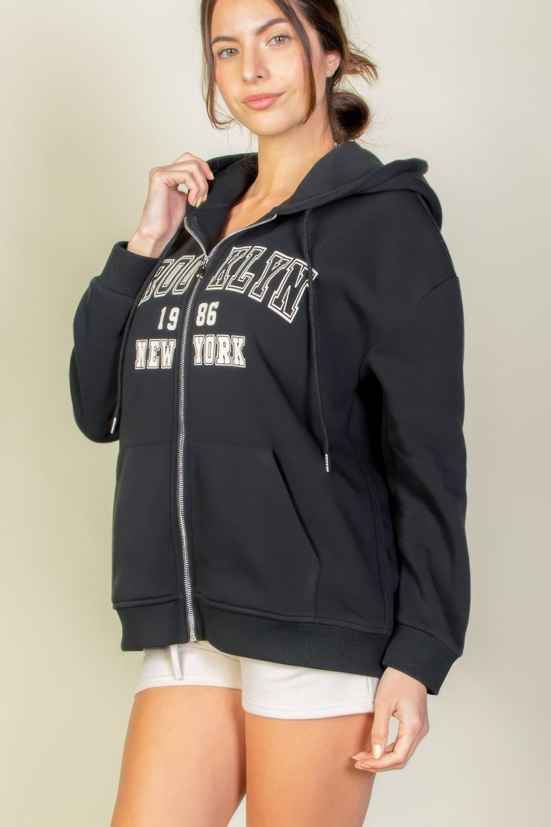 Black graphic drop shoulder full-zip hoodie with relaxed silhouette and bold streetwear print