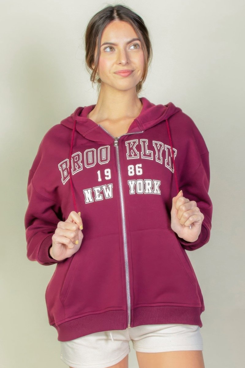Black graphic drop shoulder full-zip hoodie with relaxed fit and bold streetwear print