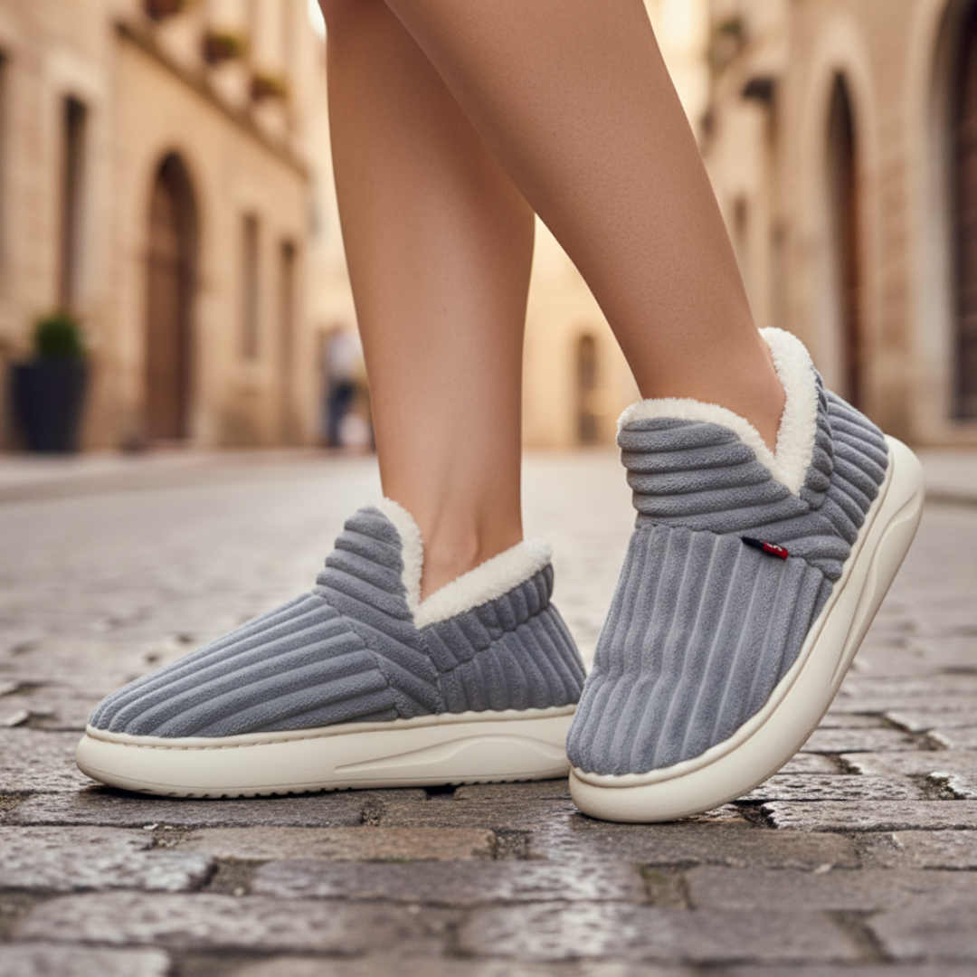 Cozy unisex home slippers with plush synthetic fur lining, soft neutral tones, slip-on style