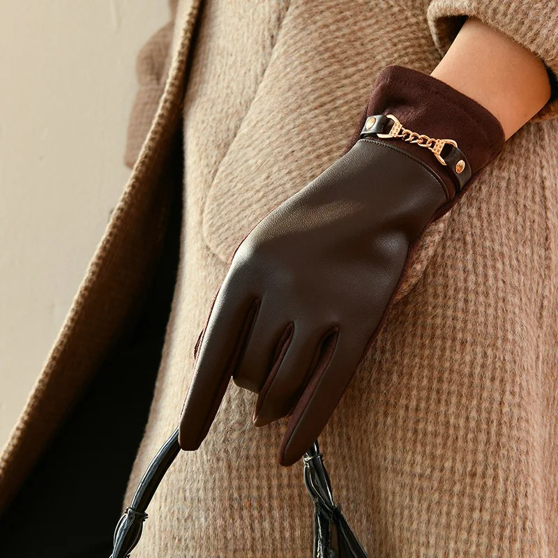 Women's black leather wrist-length gloves with gold chain accent, fitted silhouette for elegant style