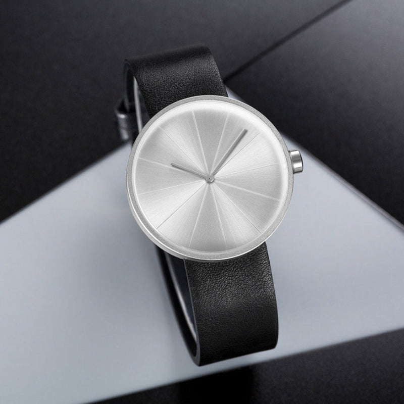 Men's minimalist round case wristwatch leather strap geometric segmented dial everyday elegance
