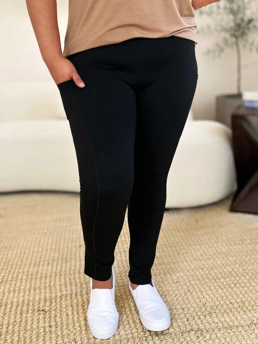 Women's black high-waist stretch active leggings with opaque fabric and flattering high-rise fit