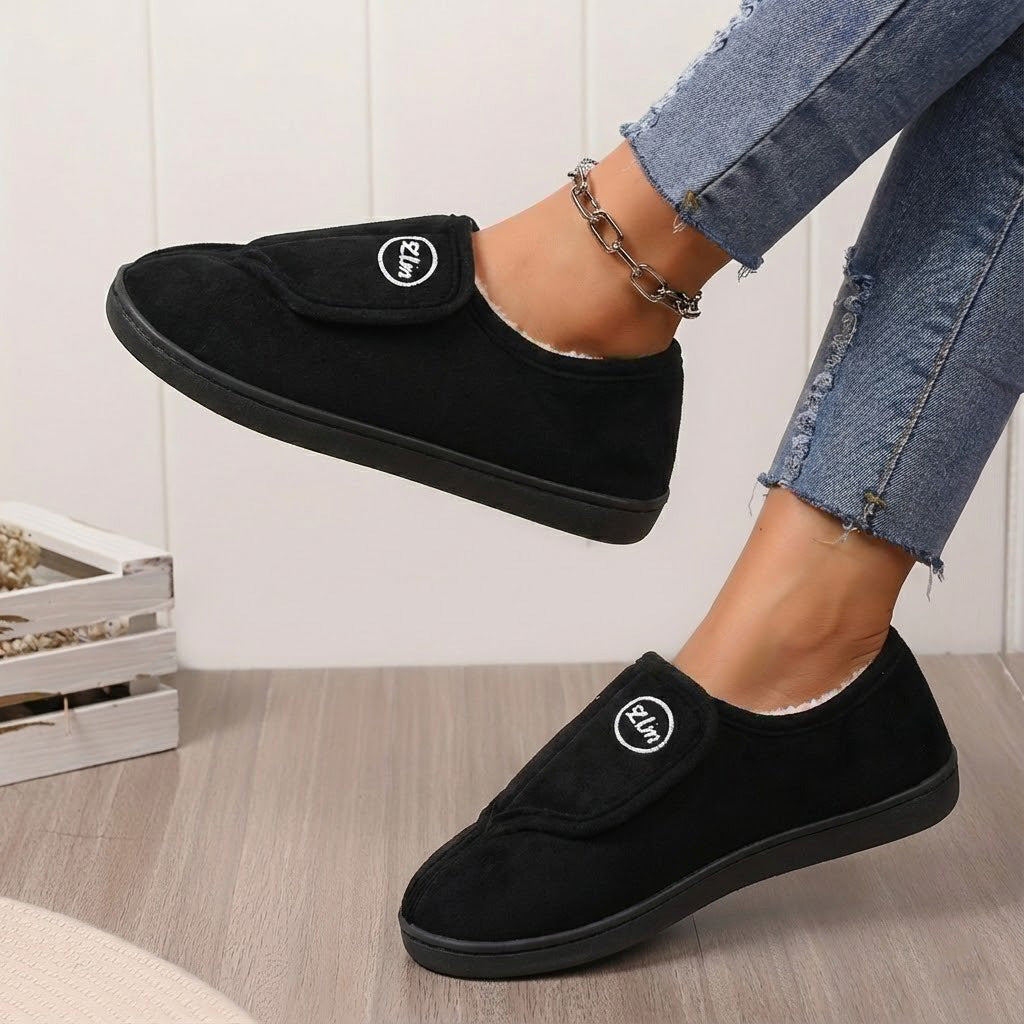 Women's wide fit fleece-lined slippers with adjustable closure and non-slip grip sole