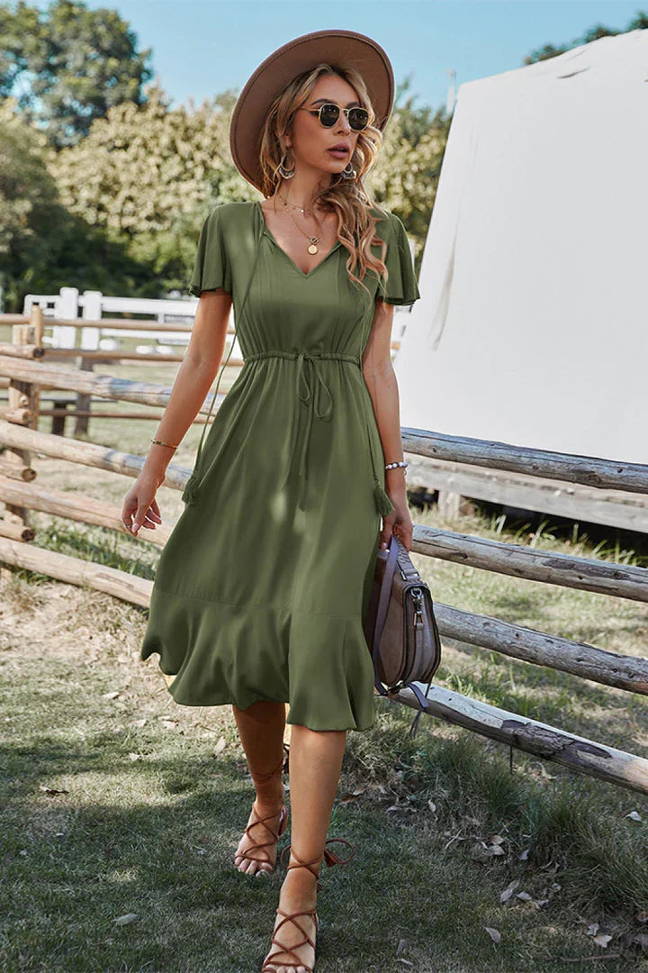 Elegant V-neck midi dress with tie waist, flattering silhouette in versatile everyday style