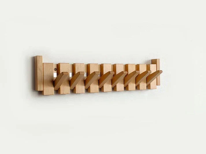 Minimalist wooden wall-mounted coat rack with staggered pegs, natural grain finish for entryway storage