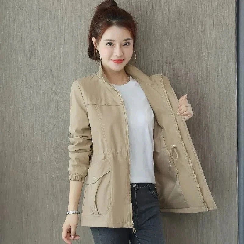 Beige lightweight trench coat with adjustable waist, clean silhouette, and spacious front pockets