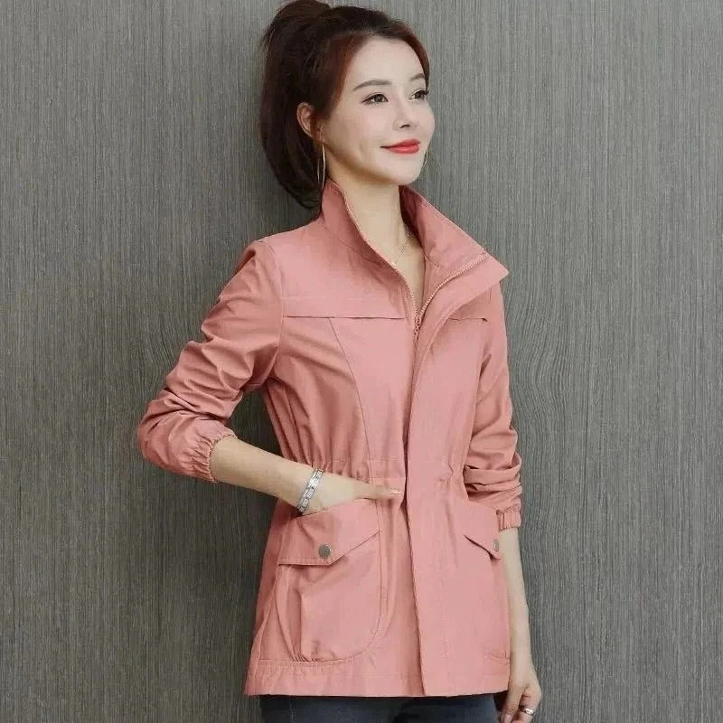 Beige lightweight trench coat with adjustable waist, clean silhouette, and spacious front pockets