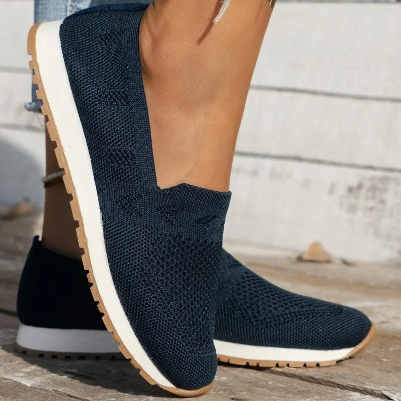 Black slip-on walking shoes with shock-absorbing outsole and textured grip sole for daily comfort