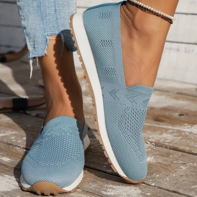 Black slip-on walking shoes with shock-absorbing outsole and textured grip sole for daily comfort