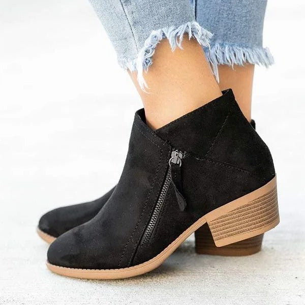 Black orthopedic ankle boots with anatomical arch support, stable heel, and everyday structured fit