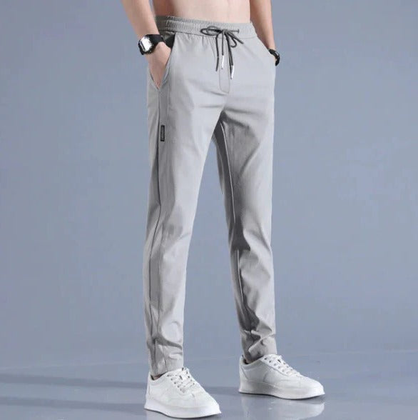 Men's lightweight quick-dry stretch pants in neutral tone, slim active fit with adjustable drawstring waist