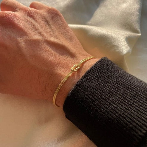 Women's minimalist gold love knot bracelet, elegant everyday jewelry with timeless knot detail