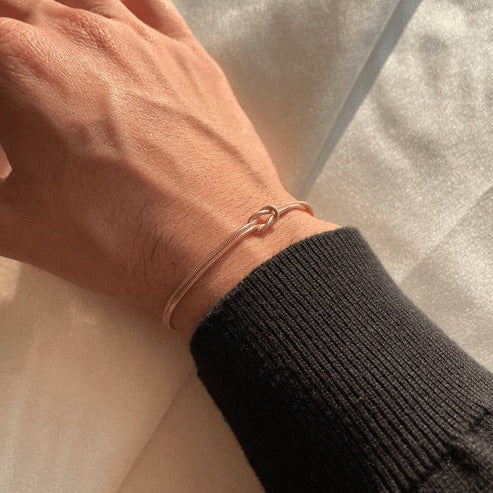 Women's minimalist love knot bracelet, elegant gold-tone everyday jewelry with classic knot detail