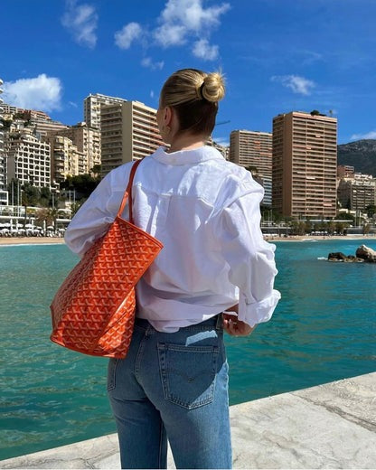 Women's structured shoulder bag with adjustable strap, spacious interior, polished everyday design
