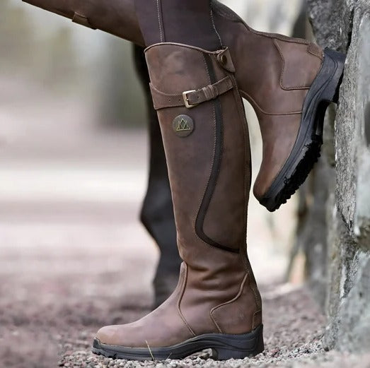 Women's waterproof knee-high boots in rugged outdoor style with non-slip grip sole for all-weather wear