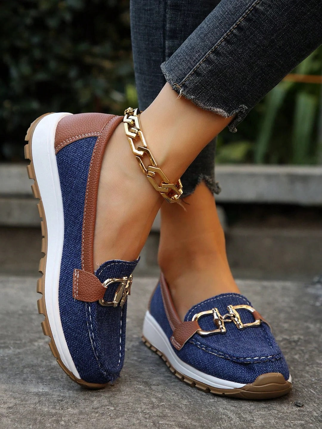 Women's black slip-on loafers with gold buckle detail, flat wedge sole for all-day comfort