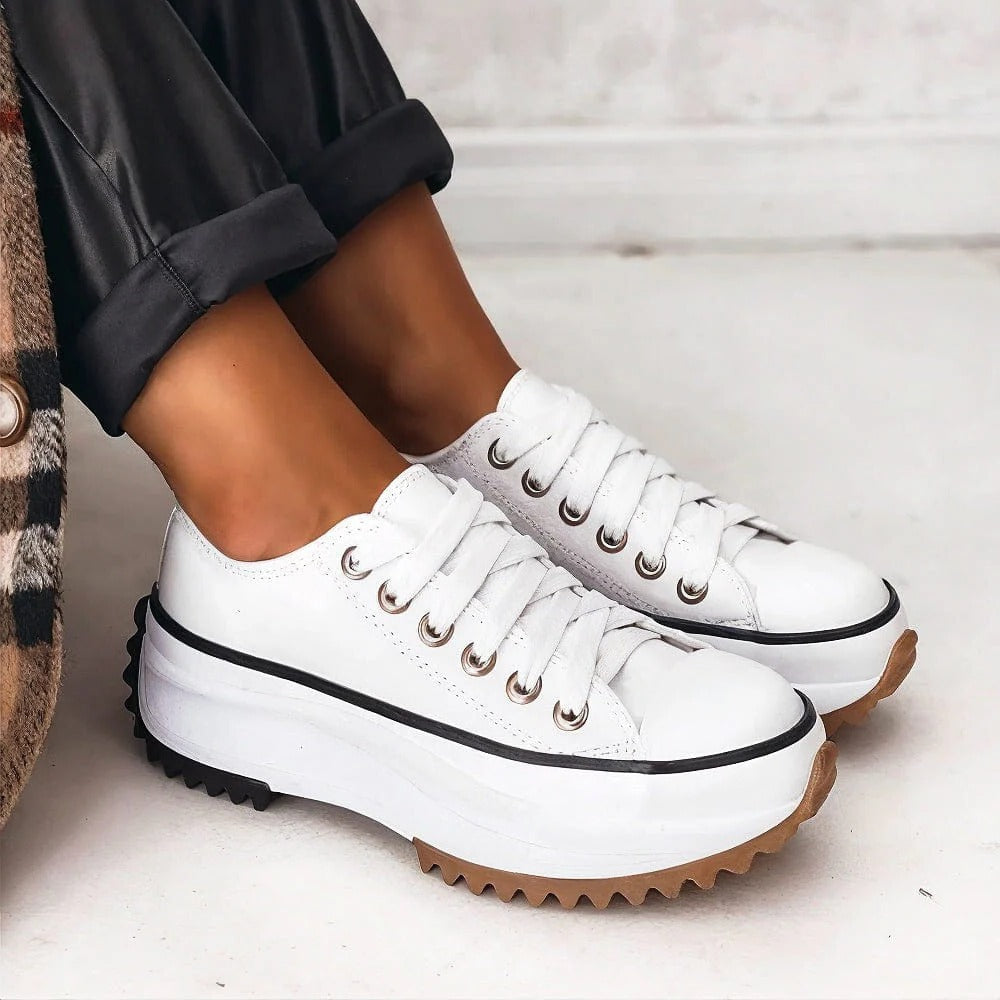 White platform low-top sneakers with cushioned sole and breathable lightweight design