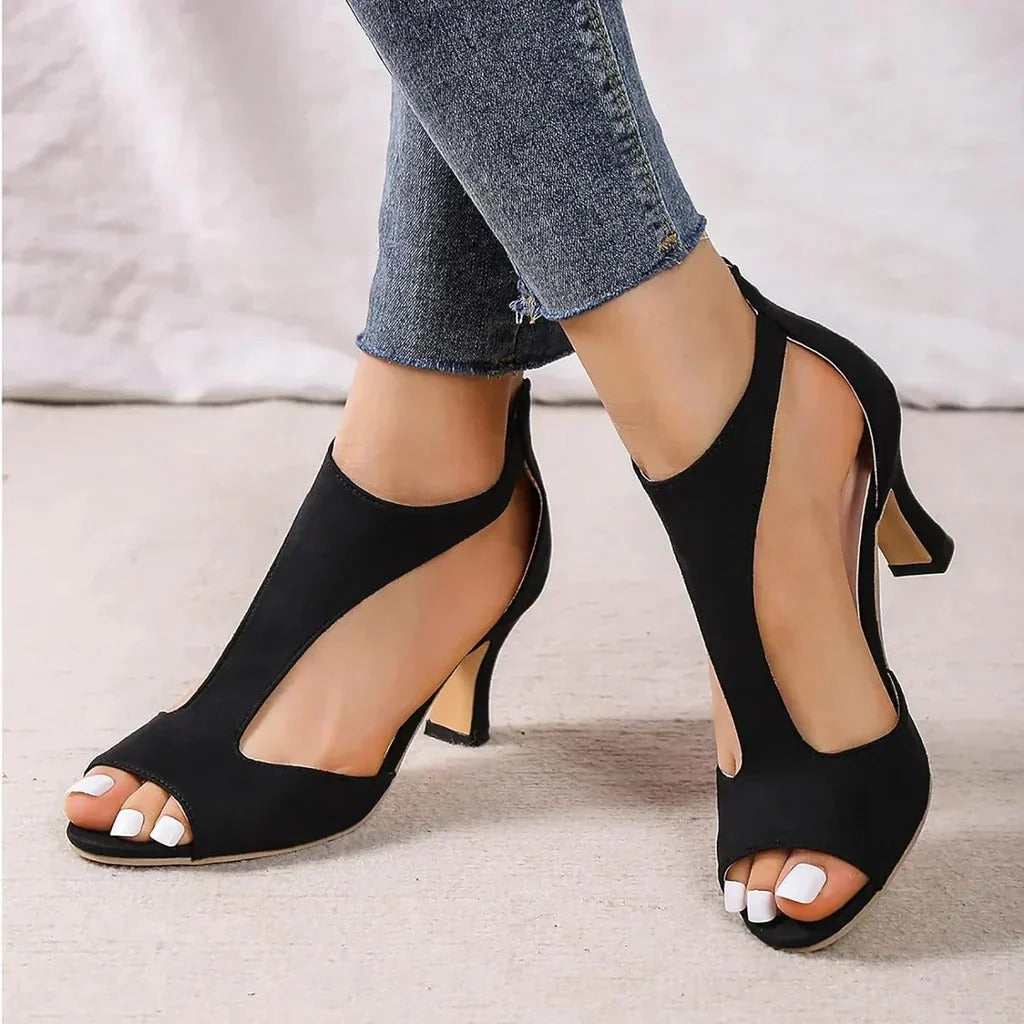 Black orthopedic high heels with cushioned insoles, alignment support, and elegant chic silhouette
