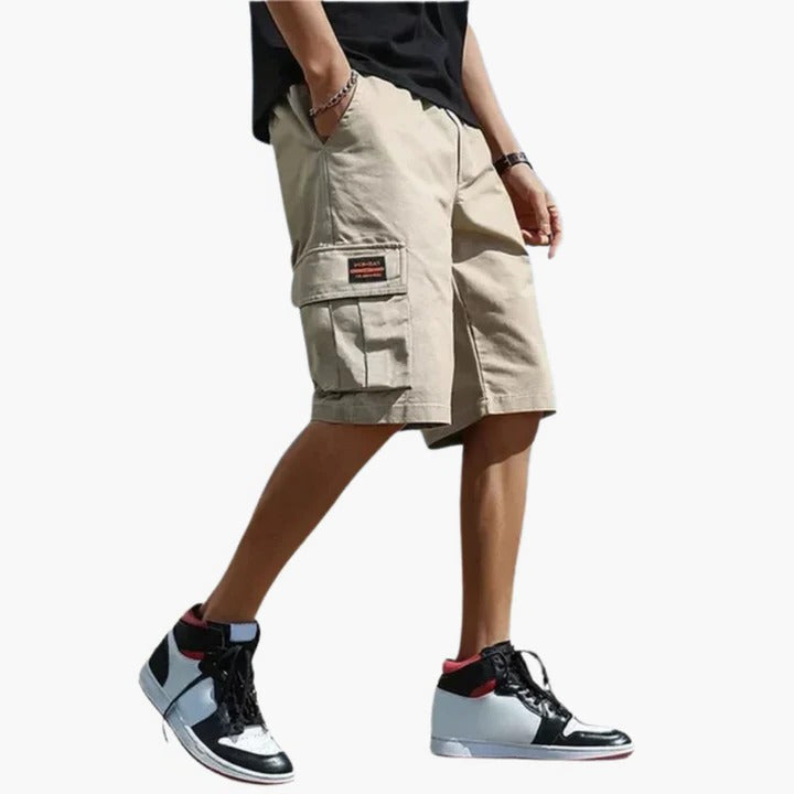 Men's khaki relaxed-fit cargo shorts with multiple utility pockets for travel and outdoor wear
