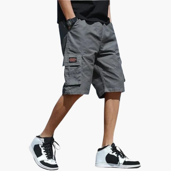Men's khaki relaxed-fit cargo shorts with multiple utility pockets for travel and outdoor comfort