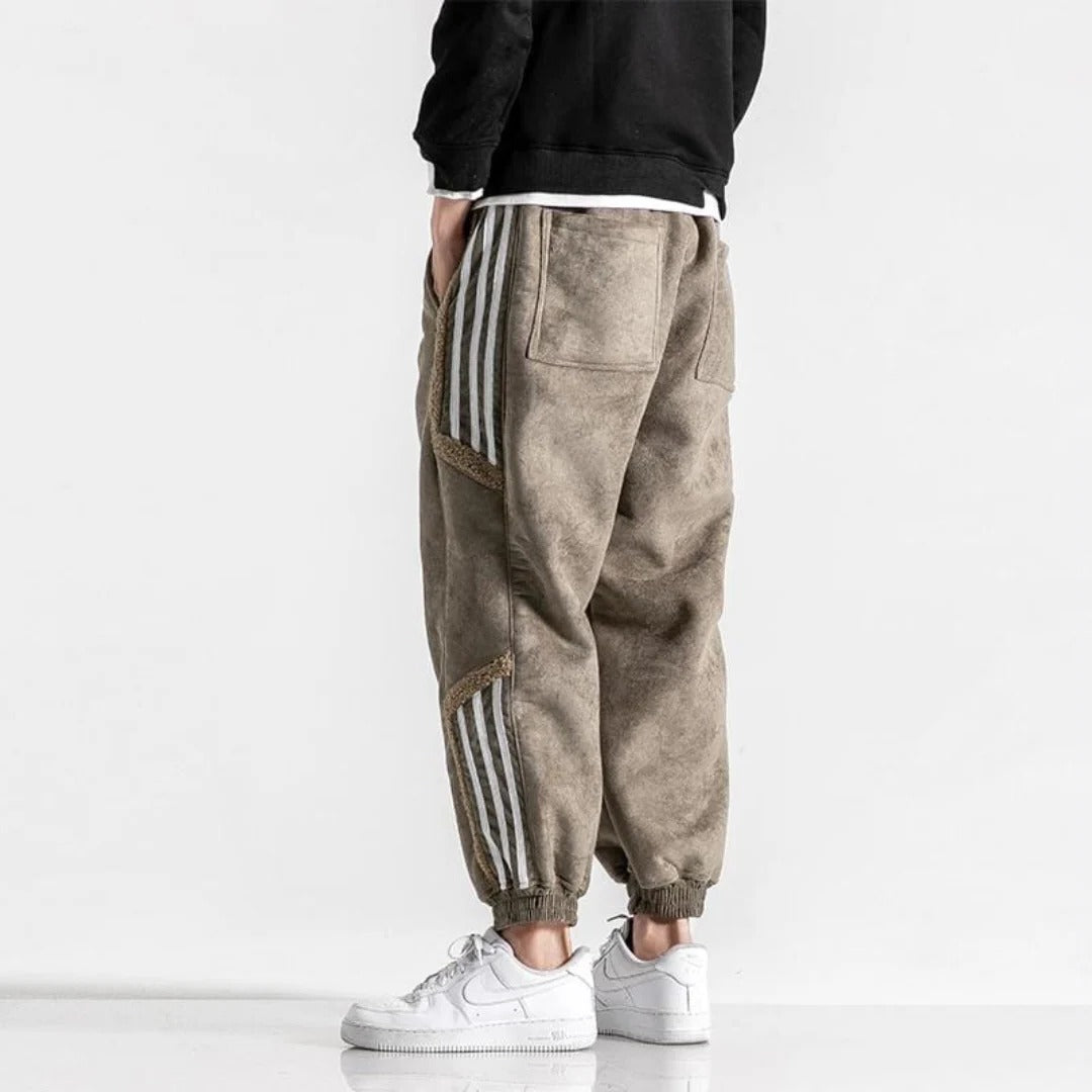 Men's black relaxed fit jogger pants with contrasting side stripes and elastic waistband for training