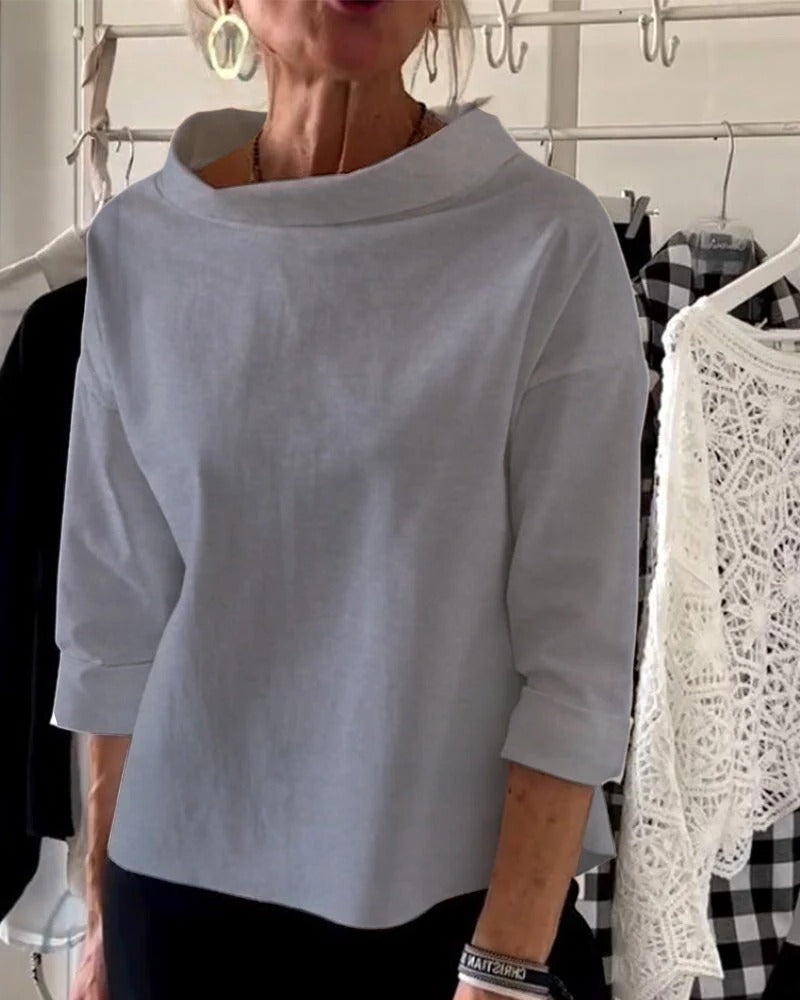 Women's elegant high-collar long sleeve top in minimalist style, versatile desk-to-dinner silhouette