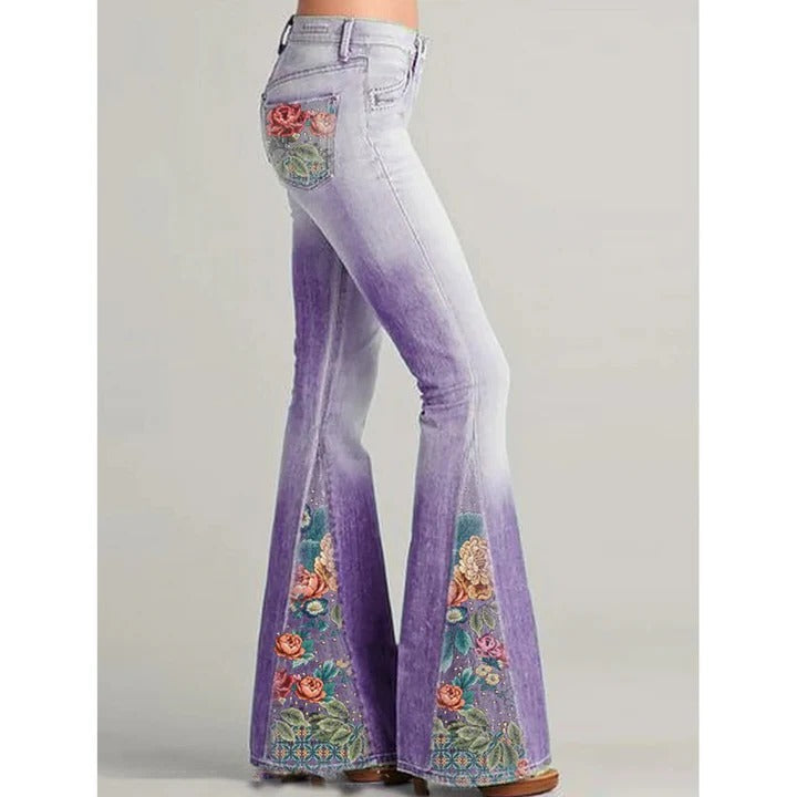 Women's blue flare jeans with intricate floral embroidery detail on pockets and legs, vintage style