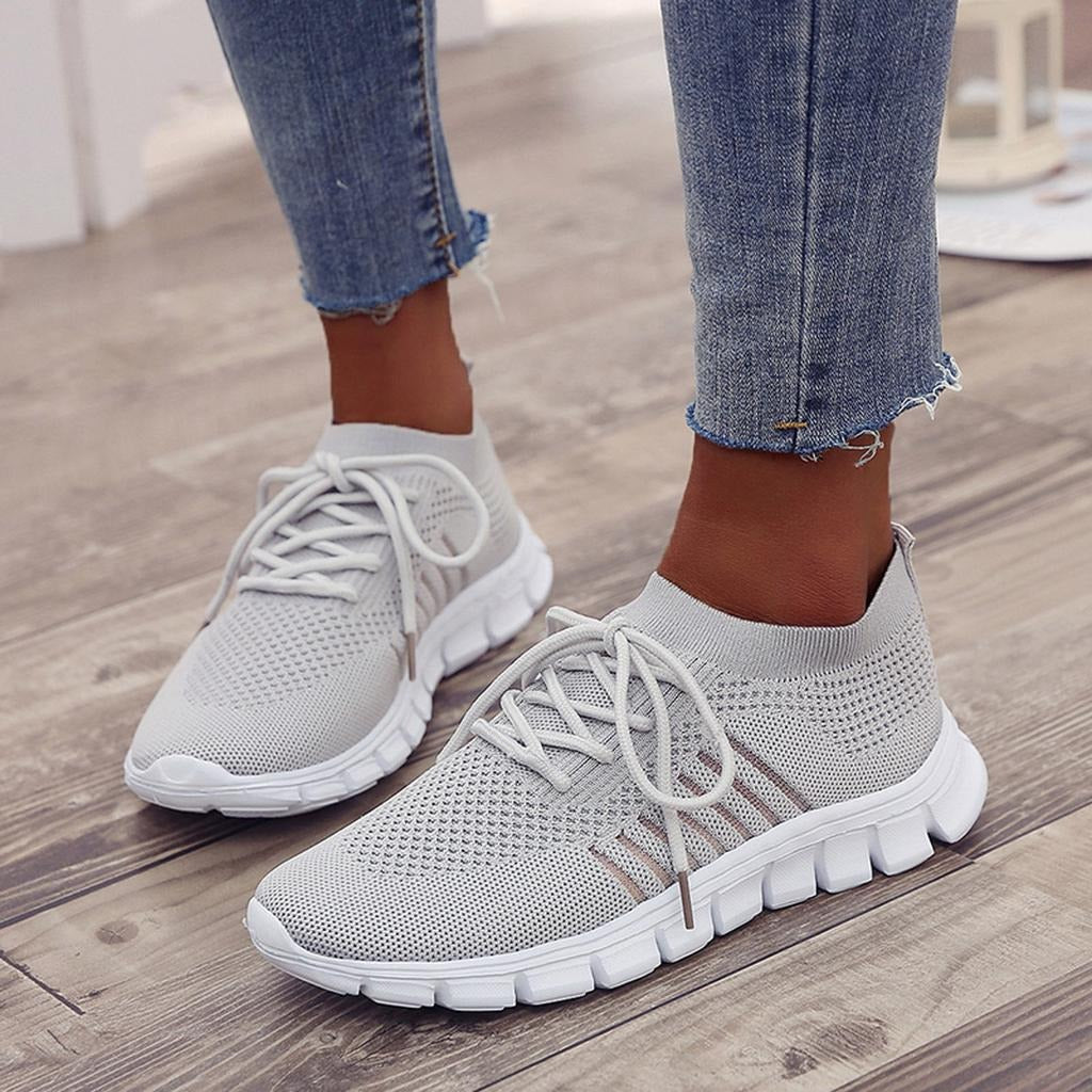 Women's white comfort walking sneakers with cushioned sole and structured full-foot support design