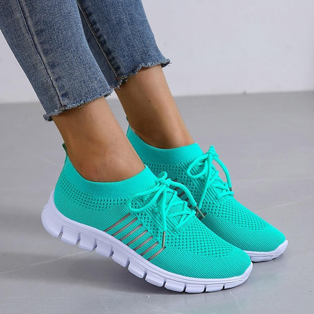 Women's white comfort walking sneakers with cushioned sole and structured full-foot support design
