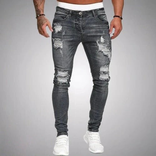 Men's slim fit ripped jeans in distressed denim with edgy torn knee accents for day-to-night style