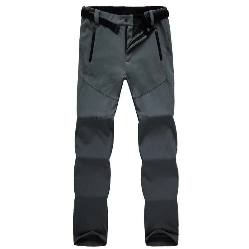 Women's weather-resistant hiking pants in neutral tones, slim fit with soft insulating lining for trekking