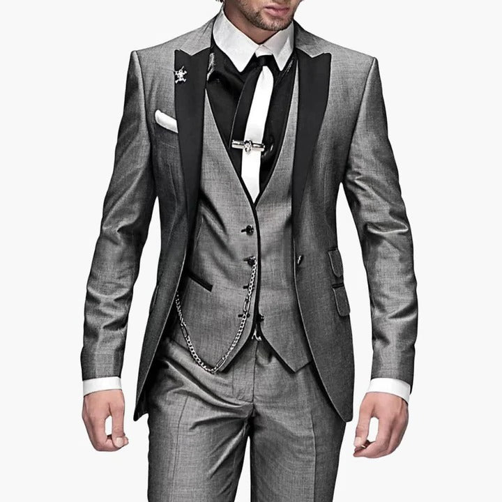 Men's burgundy three-piece tailored suit with black lapels, vest included, wedding guest formal style