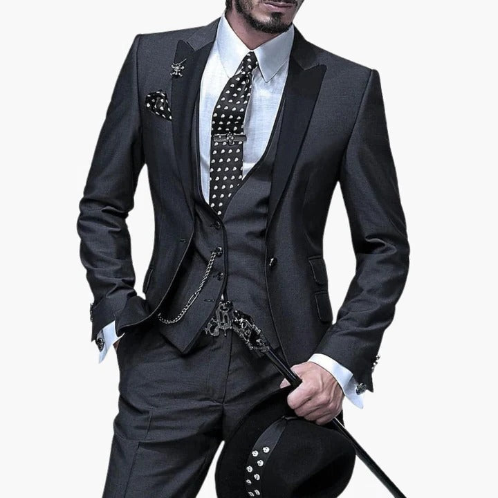 Men's burgundy three-piece tailored suit with black contrast lapels, perfect for wedding guest style