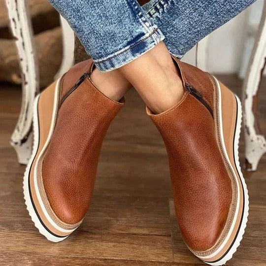 Women's low ankle boots with side zip, structured silhouette, reinforced sole, sleek everyday style