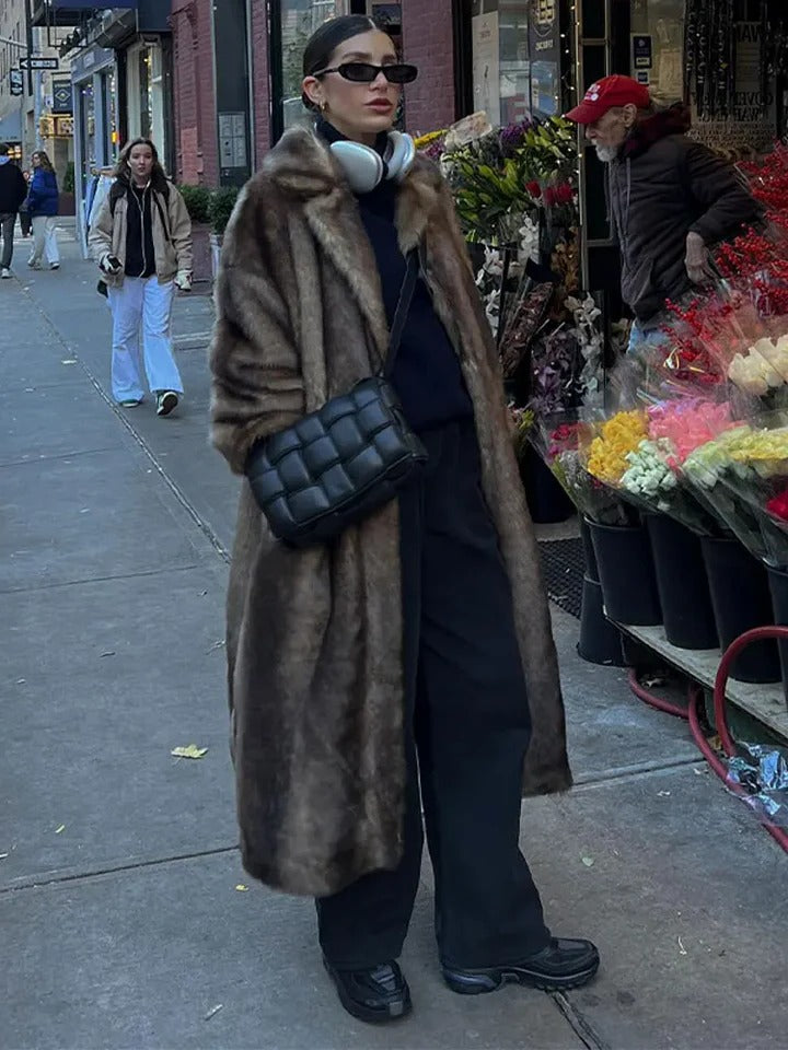 Structured long-cut winter trench coat in neutral tone, relaxed layer-friendly silhouette for cold weather