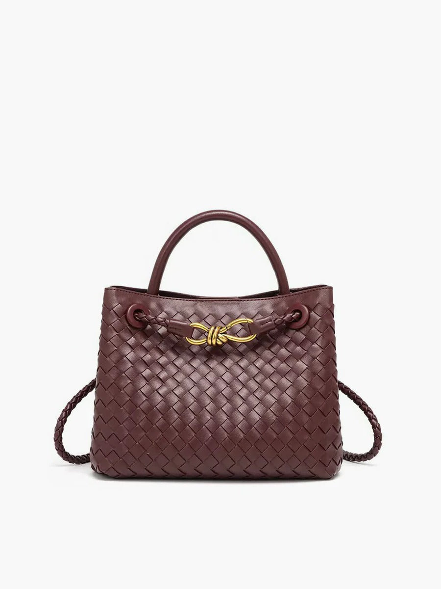 Structured black woven tote bag with gold knot accent and dual carry straps for work and school