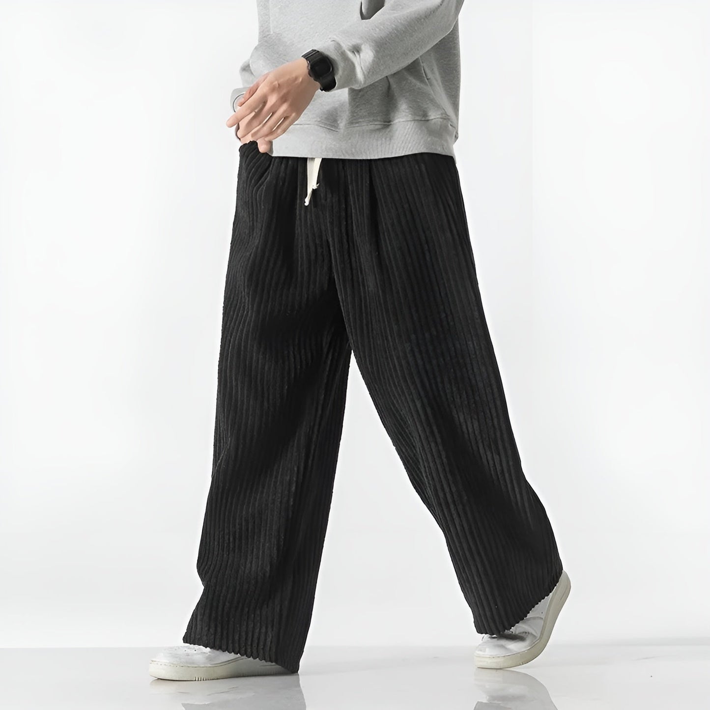 Relaxed corduroy pants in neutral tone with elastic drawstring waist and dense ribbed texture