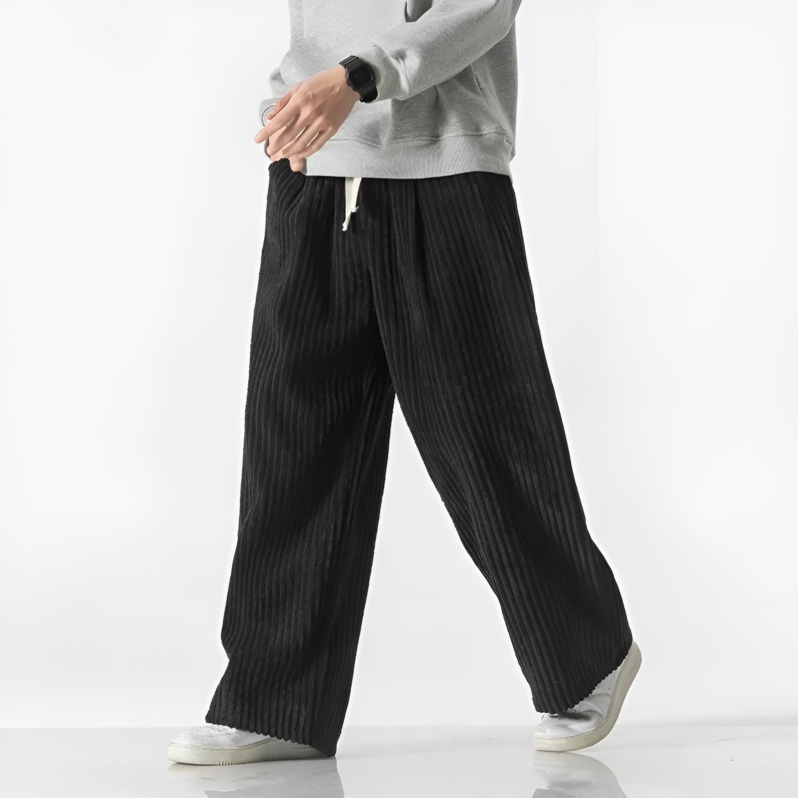 Relaxed corduroy pants in neutral tone with elastic drawstring waist and dense ribbed texture