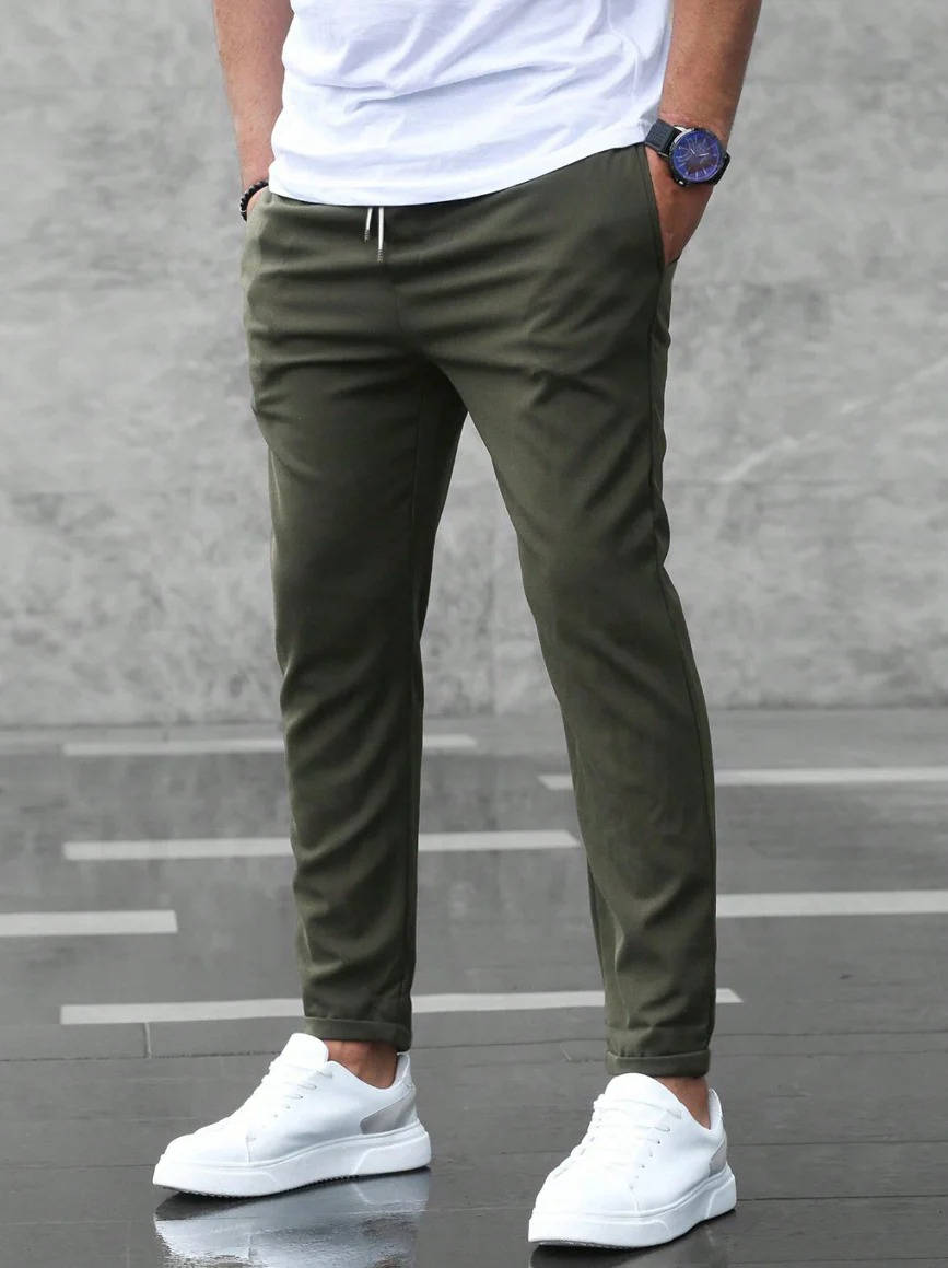 Men's casual stretch pants in neutral tone, slim tailored cut with adaptive comfort waistband for office wear