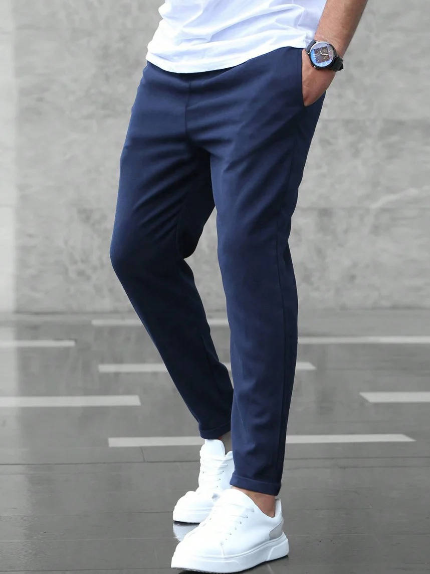 Men's casual stretch pants in neutral tone, slim-fit silhouette with adaptive comfort waistband for office wear