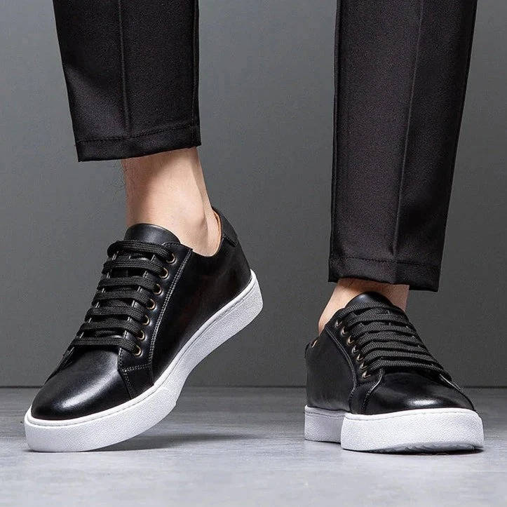 Men's low-top genuine leather sneakers in classic neutral tones with sleek profile and premium textured upper