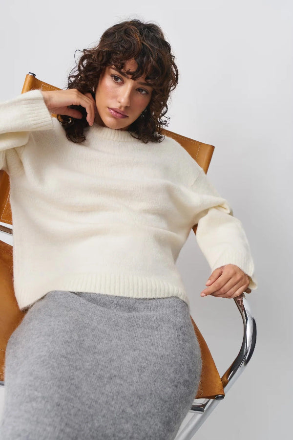 Women's oversized mid-length pullover sweater soft wool-feel fabric ribbed trim relaxed drapey silhouette
