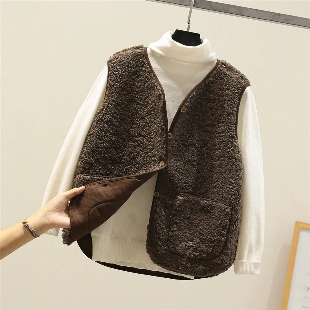 Women's hip-length puffer gilet in sherpa fleece with button front closure for cozy layered warmth