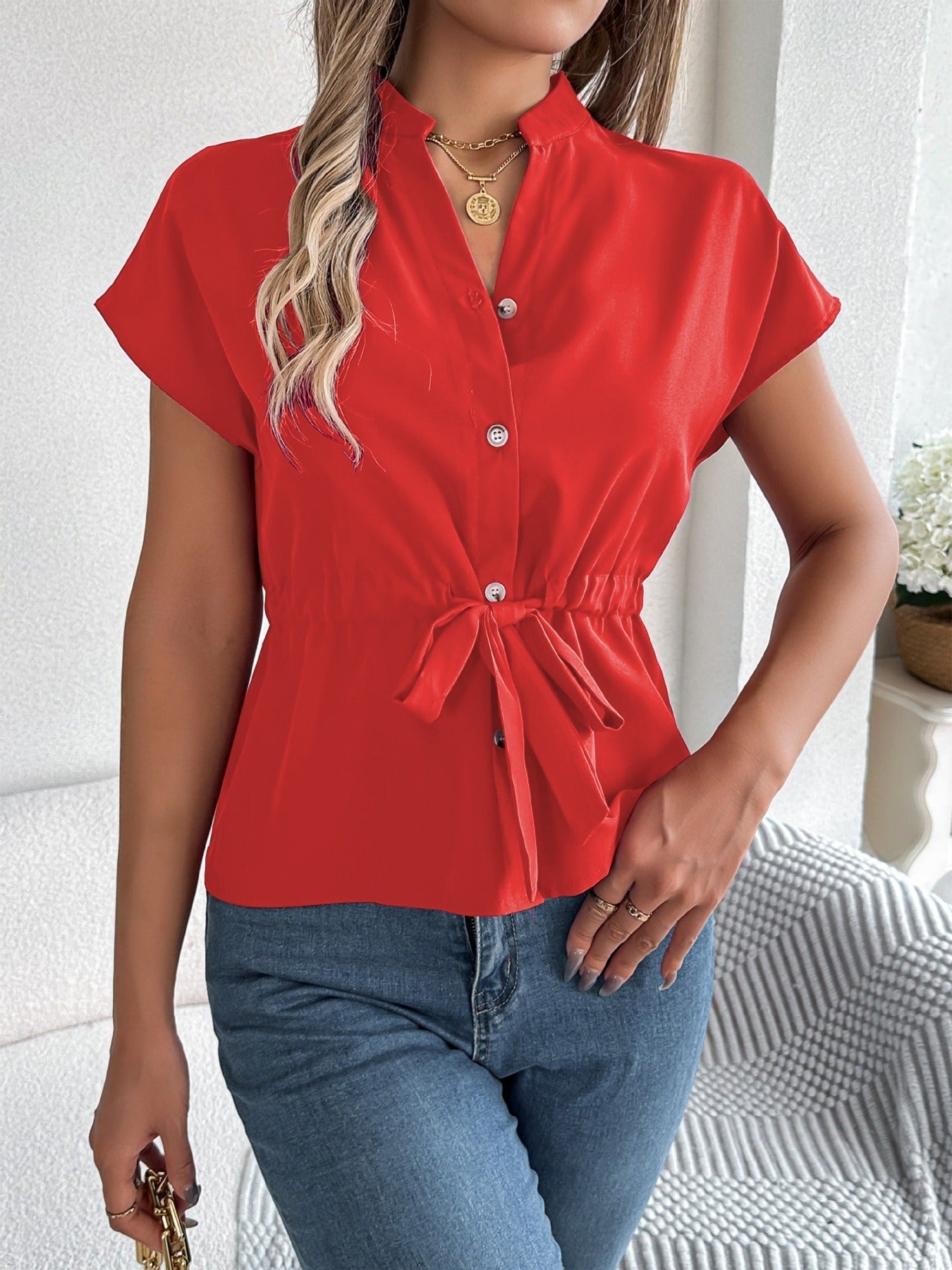 Women's cotton blend relaxed fit V-neck shirt with short sleeves, button front, and waist tie detail